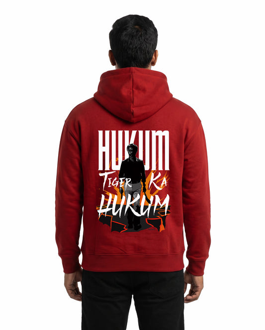 Back view of male model wearing ORDER OF THE TIGER - Unisex Regular Fit Hoodie in red in a studio setting.