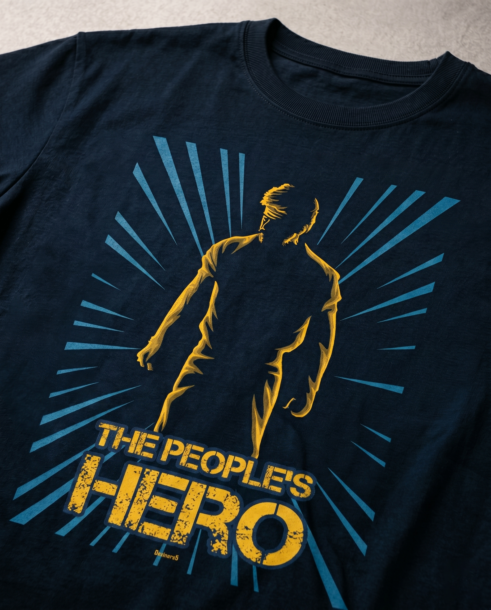 Close-up view of the PEOPLE'S HERO front graphic print highlighting print quality and design details on a navy blue men's regular-fit t-shirt.