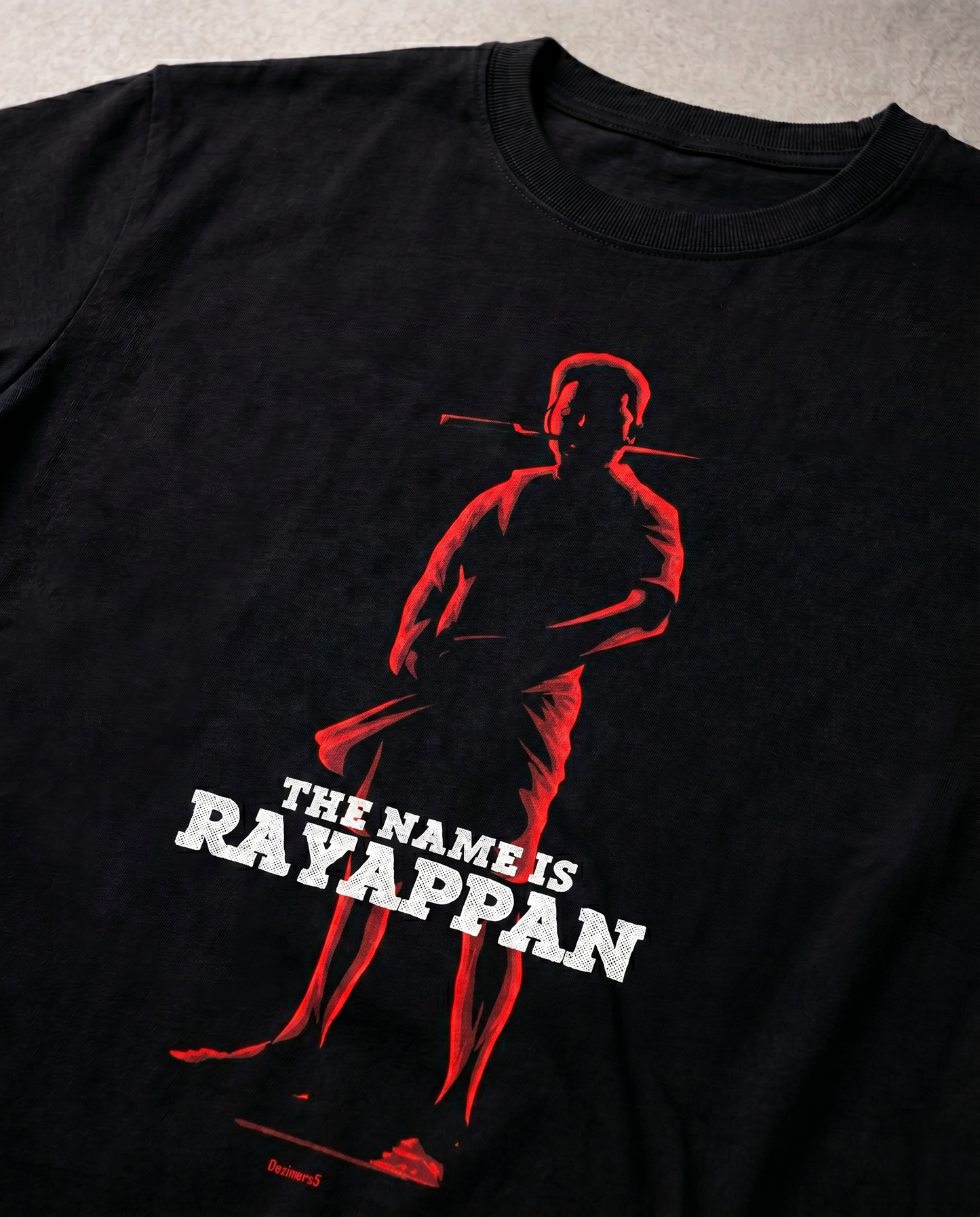 Detailed close-up of the RAYAPPAN TRIBUTE front graphic print highlighting premium print quality and design details on a black men's regular-fit t-shirt.