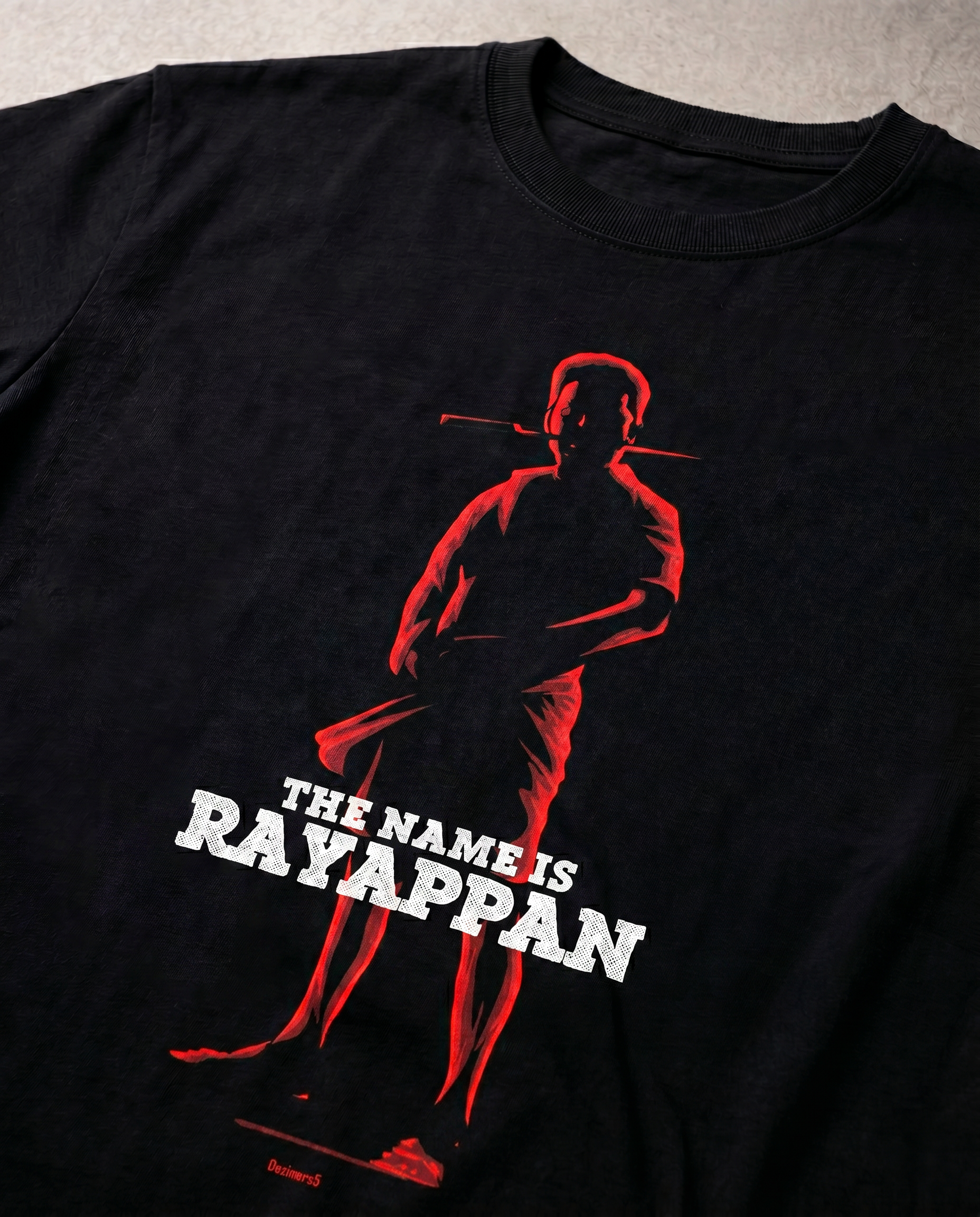 Detailed close-up of the RAYAPPAN TRIBUTE front graphic print highlighting premium print quality and design details on a black men's regular-fit t-shirt.