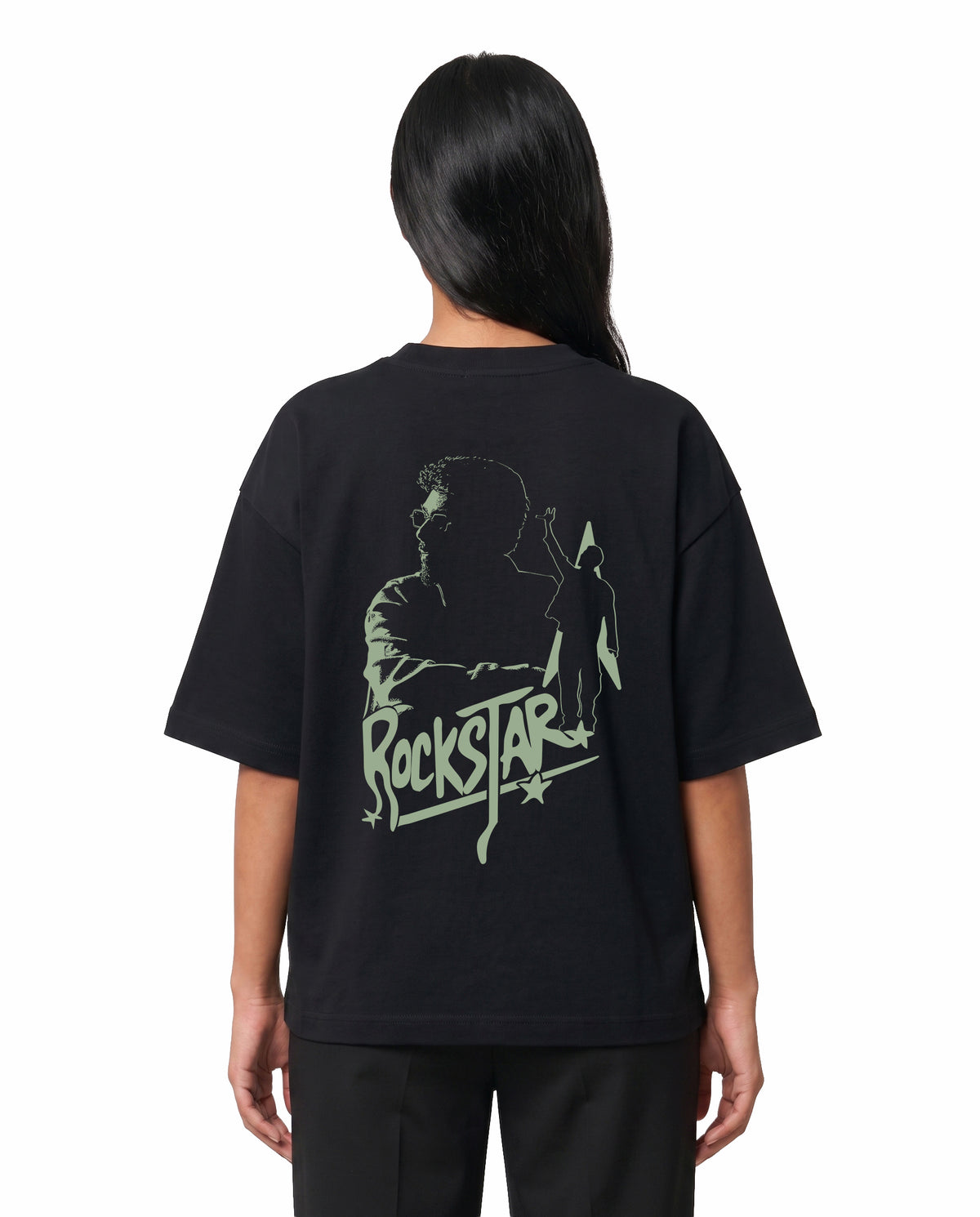 Back view of female model wearing ROCKSTAR - Unisex Oversized Graphic T-Shirt in black in a studio setting.