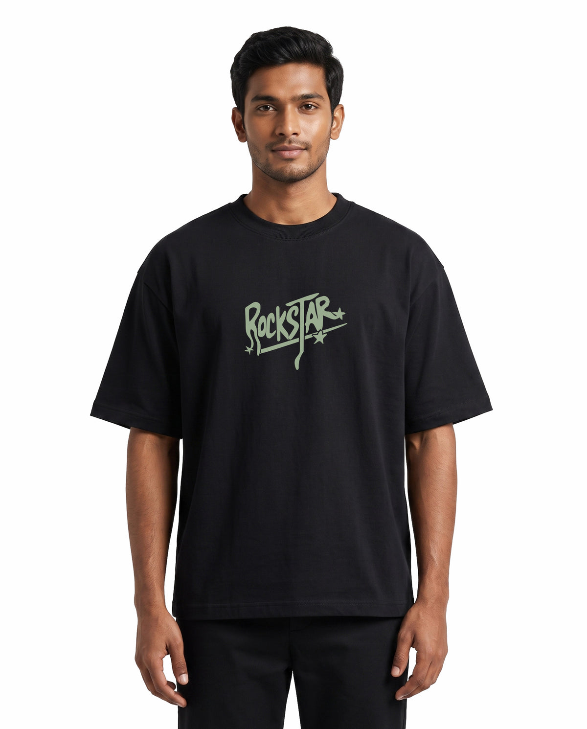 Front view of male model wearing ROCKSTAR - Unisex Oversized Graphic T-Shirt in black in a studio setting.