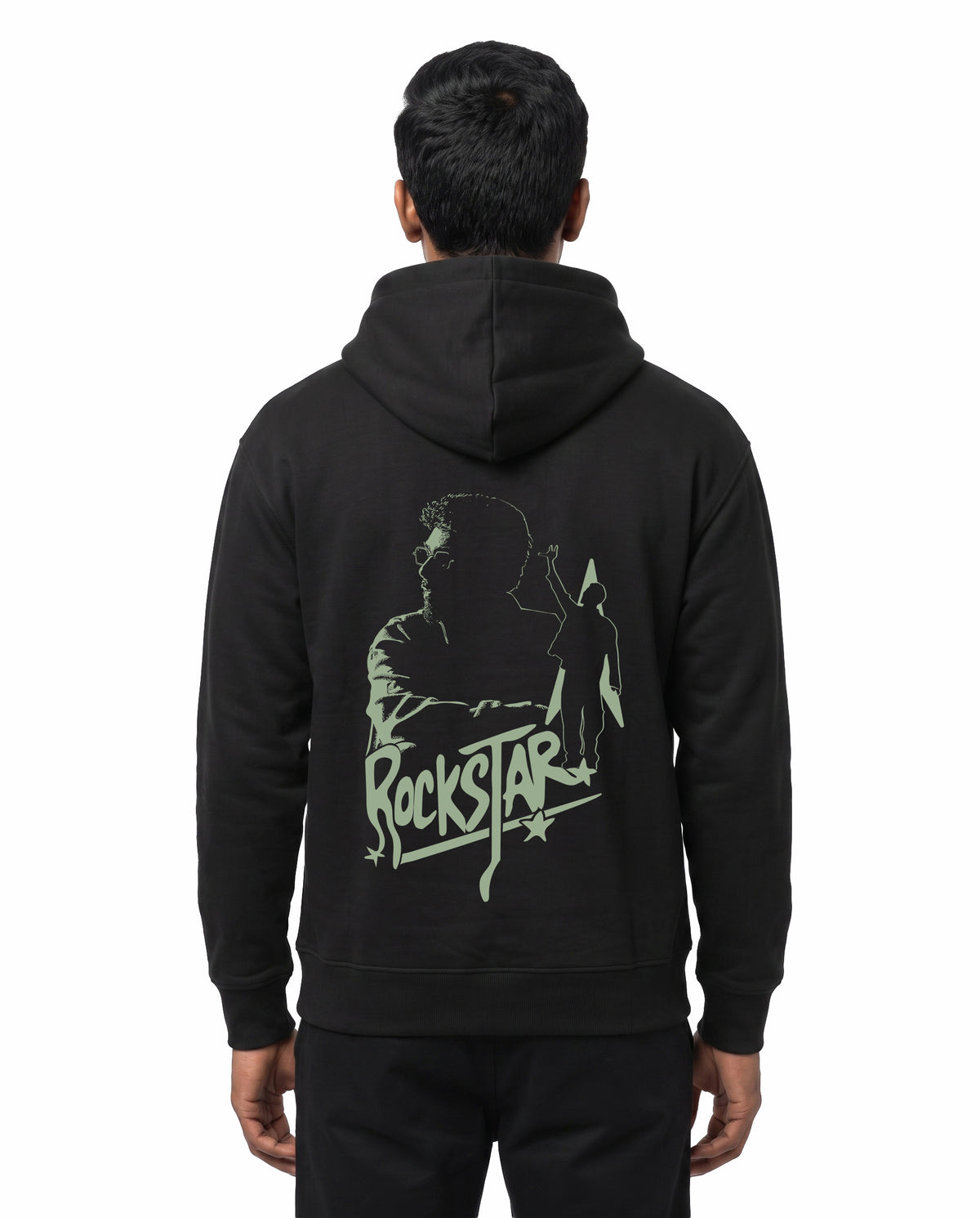Back view of male model wearing ROCKSTAR - Unisex Regular Fit Hoodie in black in a studio setting.