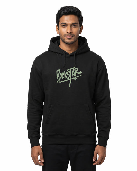 Front view of male model wearing ROCKSTAR - Unisex Regular Fit Hoodie in black in a studio setting.