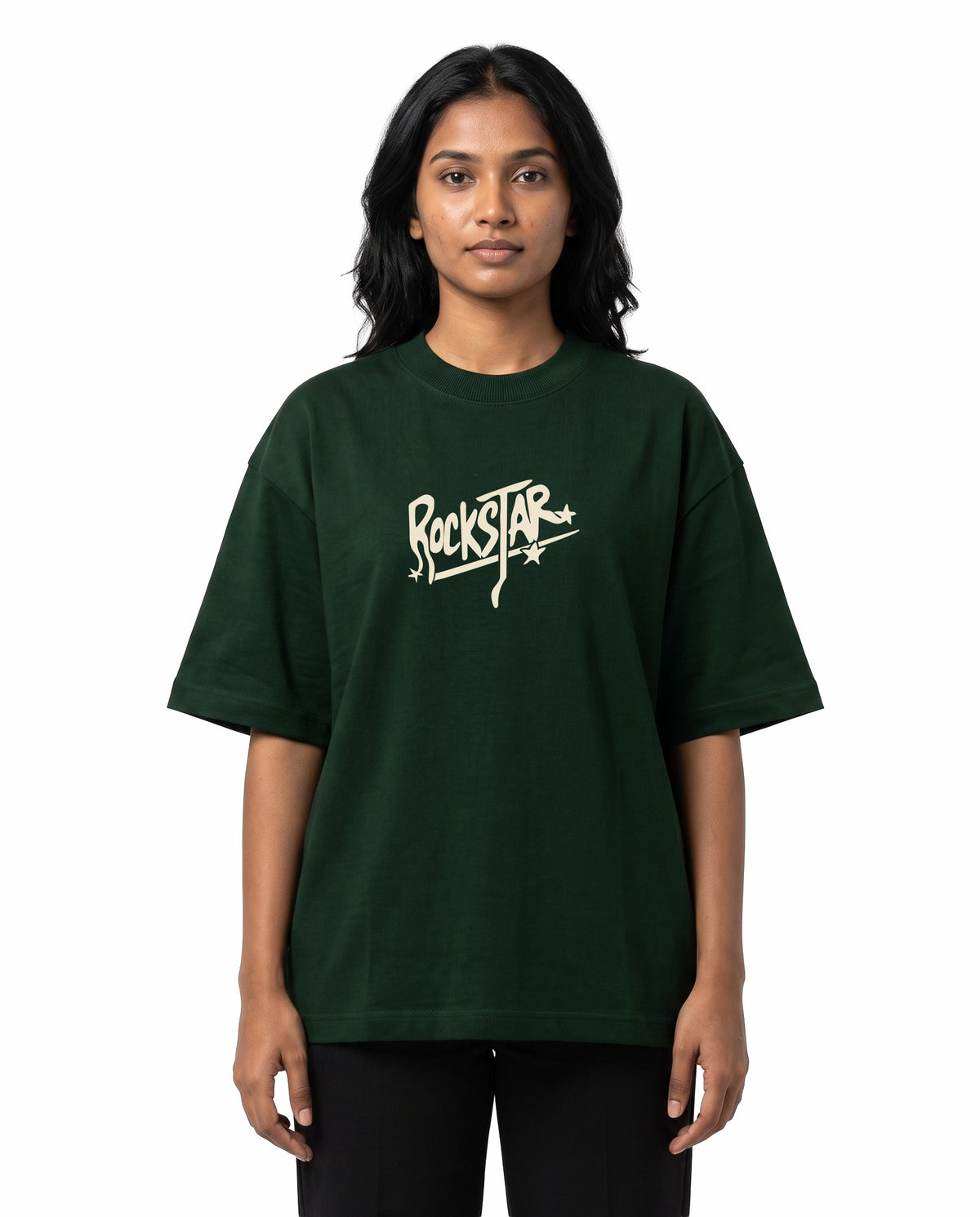 Front view of female model wearing ROCKSTAR - Unisex Oversized Graphic T-Shirt in bottle green in a studio setting.