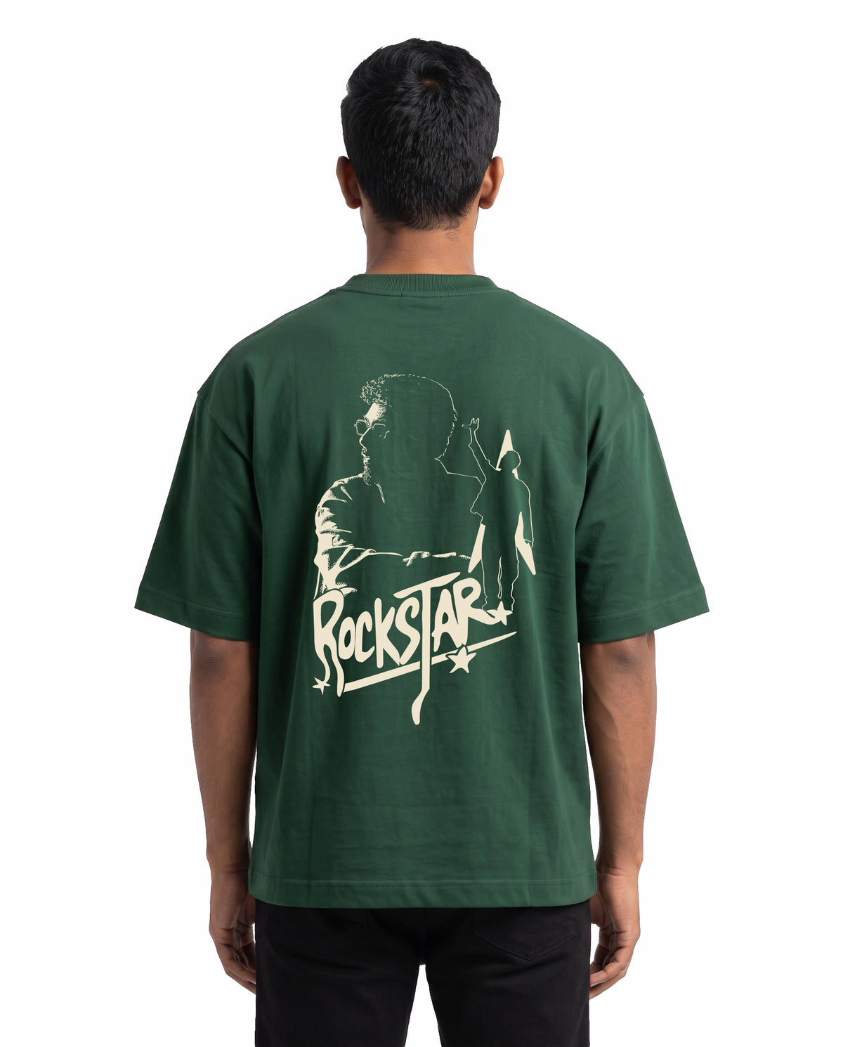 Back view of male model wearing ROCKSTAR - Unisex Oversized Graphic T-Shirt in bottle green in a studio setting.