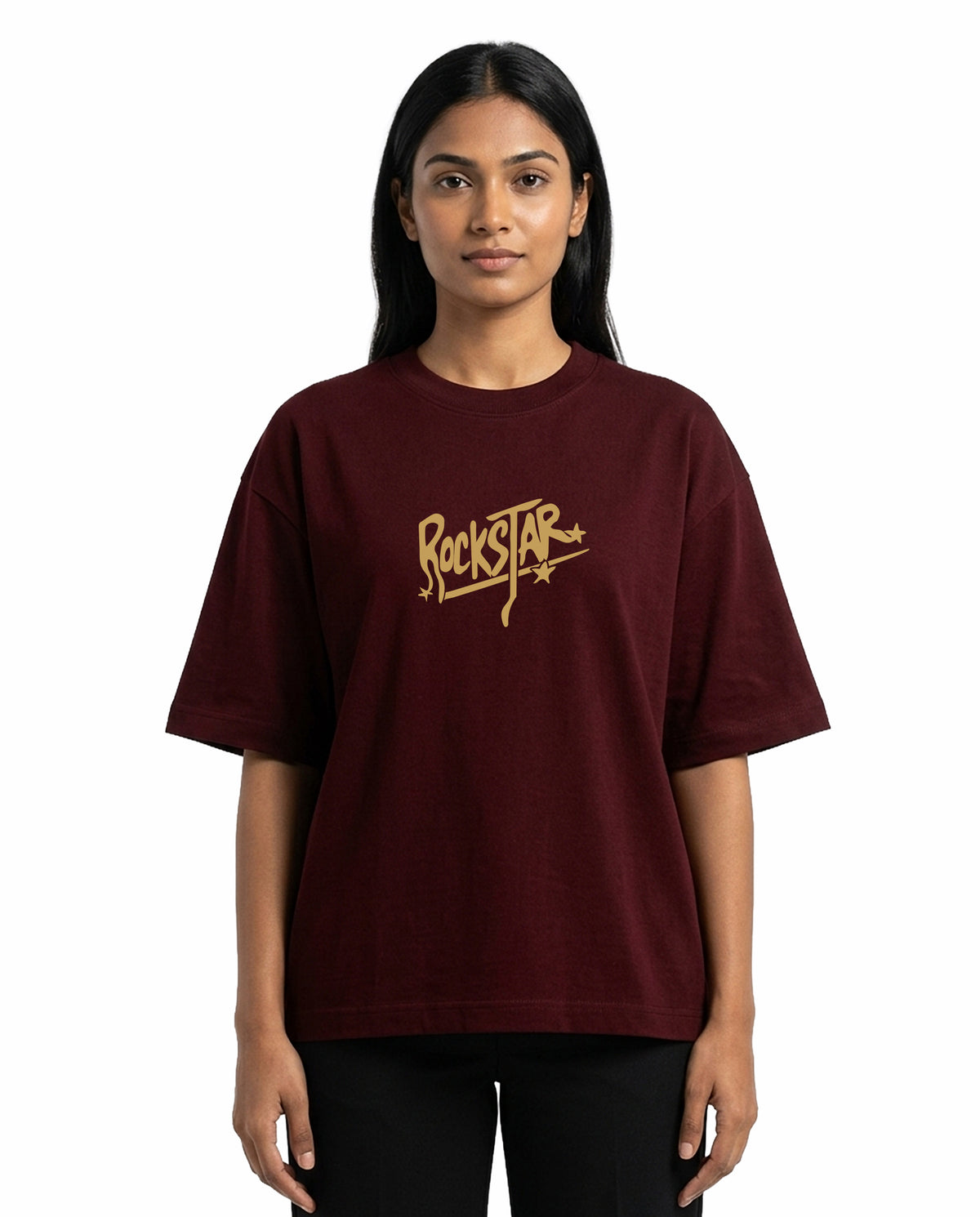 Front view of female model wearing ROCKSTAR - Unisex Oversized Graphic T-Shirt in maroon in a studio setting.