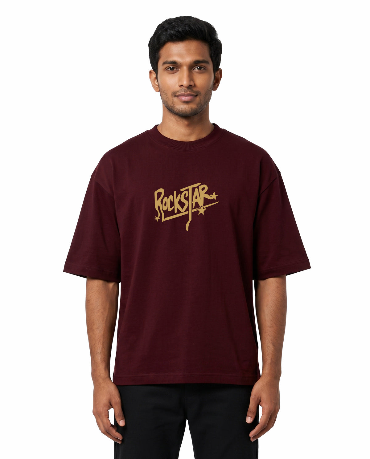 Front view of male model wearing ROCKSTAR - Unisex Oversized Graphic T-Shirt in maroon in a studio setting.