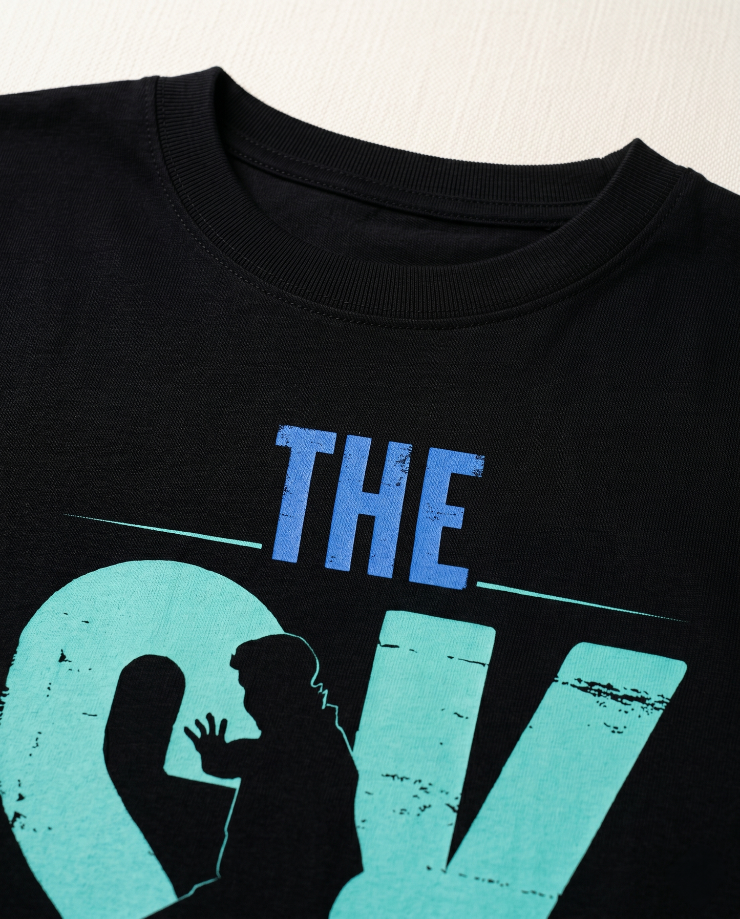 Detailed close-up of the SK FAN graphic print showcasing premium print quality and minimalist design elements on a black men's regular-fit t-shirt.