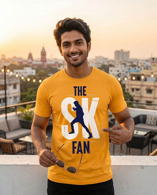Young South Indian male wearing the SK FAN men's regular-fit t-shirt in golden yellow in an energetic urban lifestyle setting.