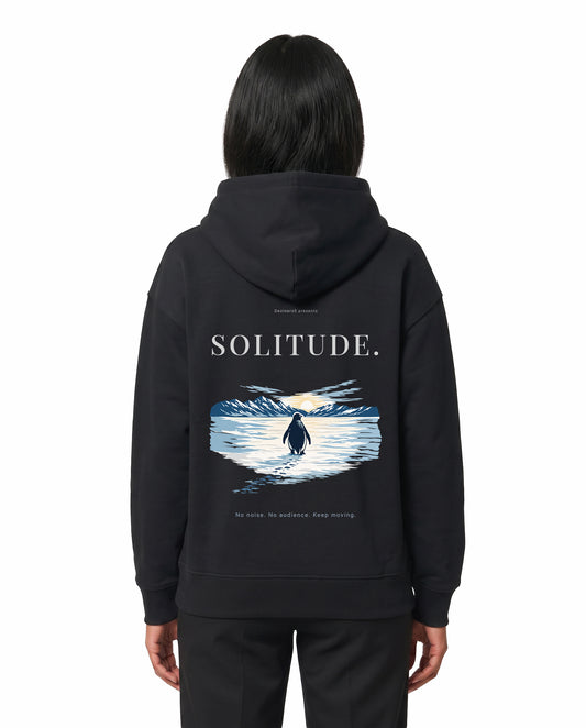Back view of female model wearing SOLITUDE - unisex regular-fit hoodie in black in a studio setting.
