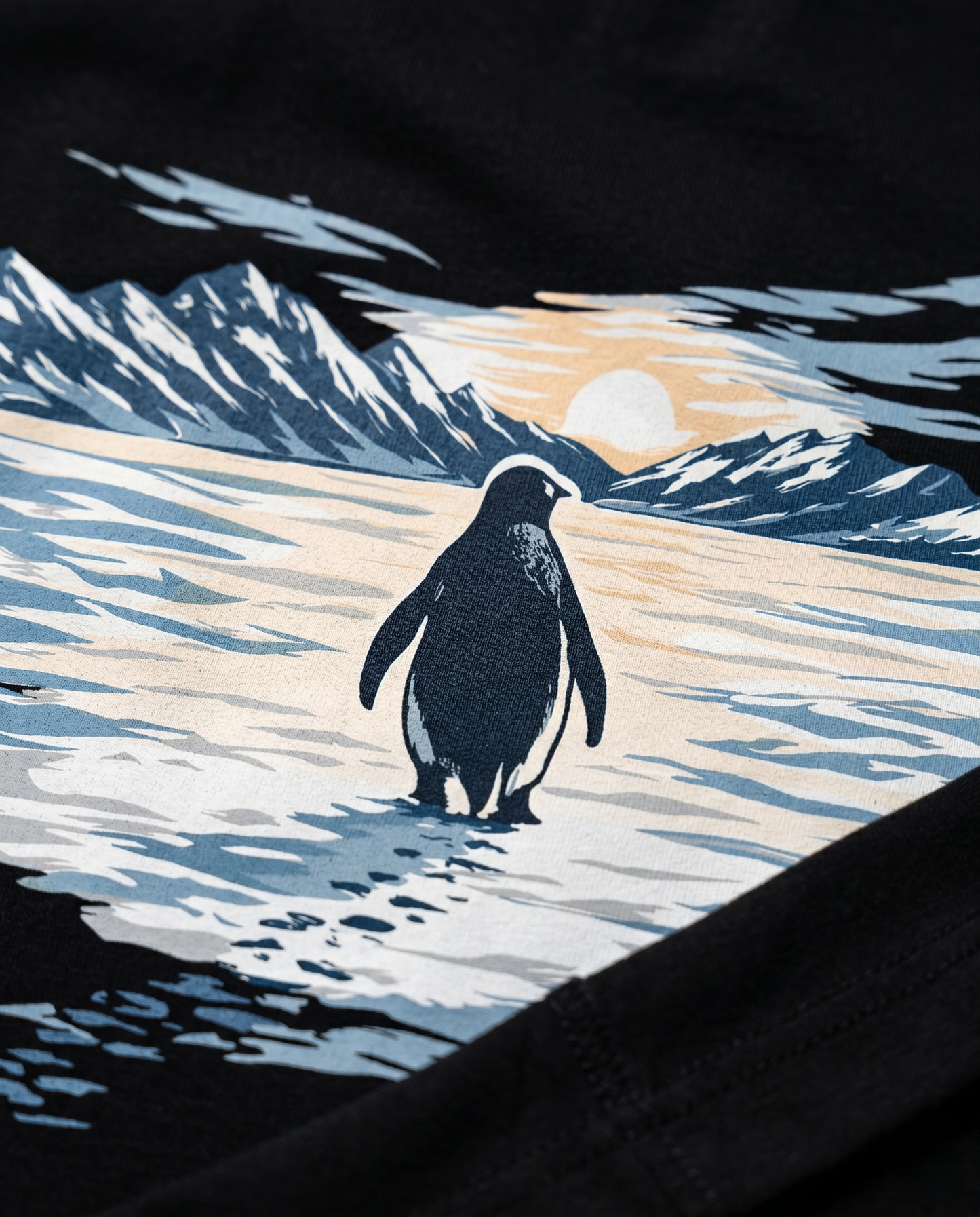 Macro detail of the SOLITUDE - unisex oversized graphic t-shirt in black showing premium DTG print quality, penguin illustration detail and heavyweight cotton texture.