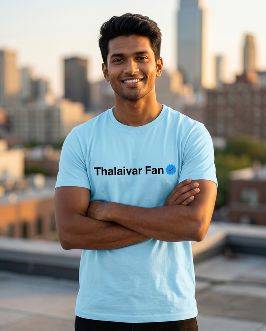 Young South Indian male wearing the THALAIVAR FAN VERIFIED men's regular-fit t-shirt in Baby Blue, proudly showcasing the checklist-inspired graphic print in a modern lifestyle setting with the model highlighting the front artwork.