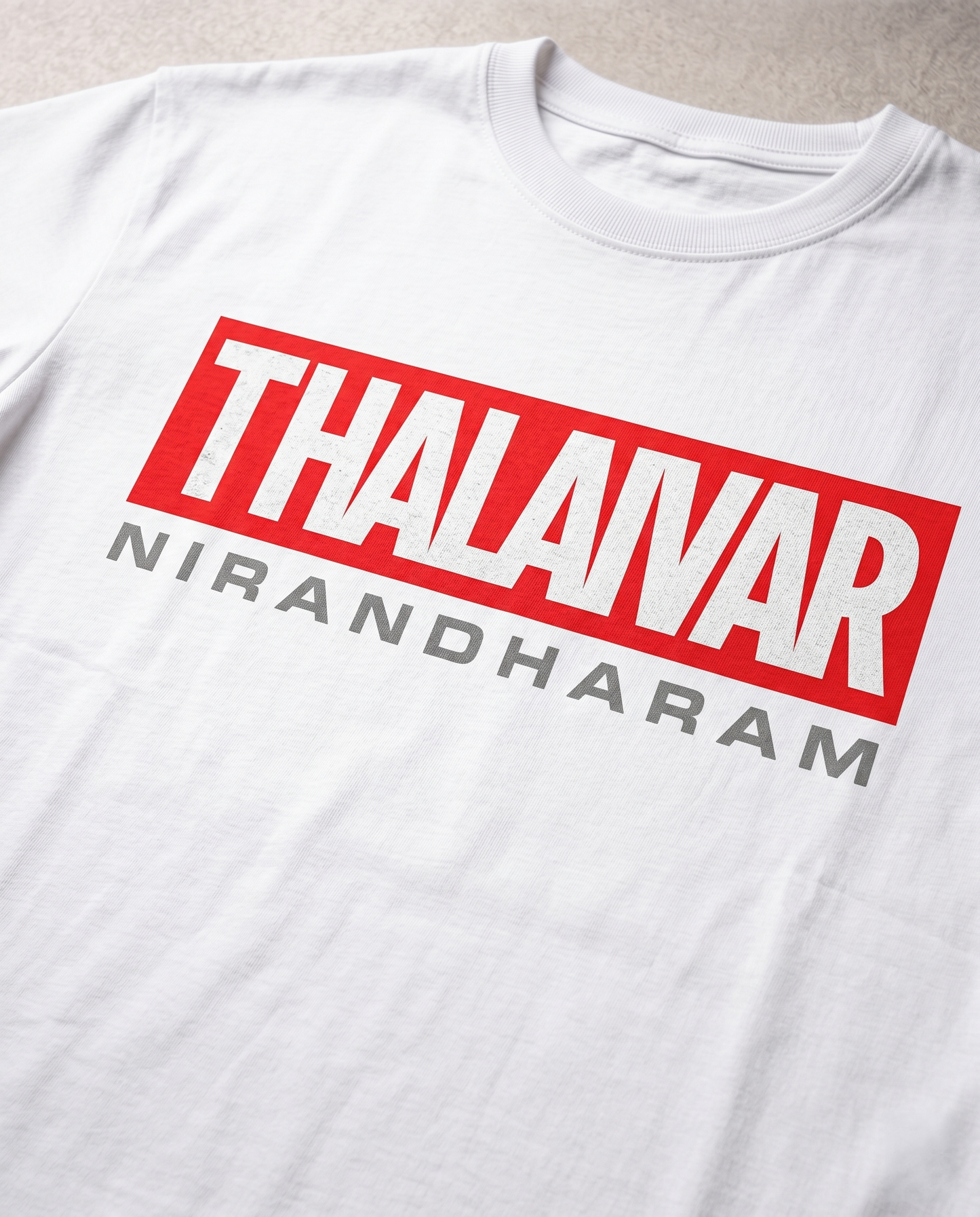 Close-up print detail of THALAIVAR NIRANDHARAM Superstar tribute artwork on white regular fit t-shirt.