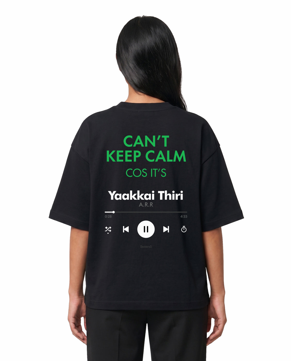 Back view of female model wearing THE ARR TRACK - TAMIZH - Unisex Oversized Graphic T-Shirt in black in a studio setting.