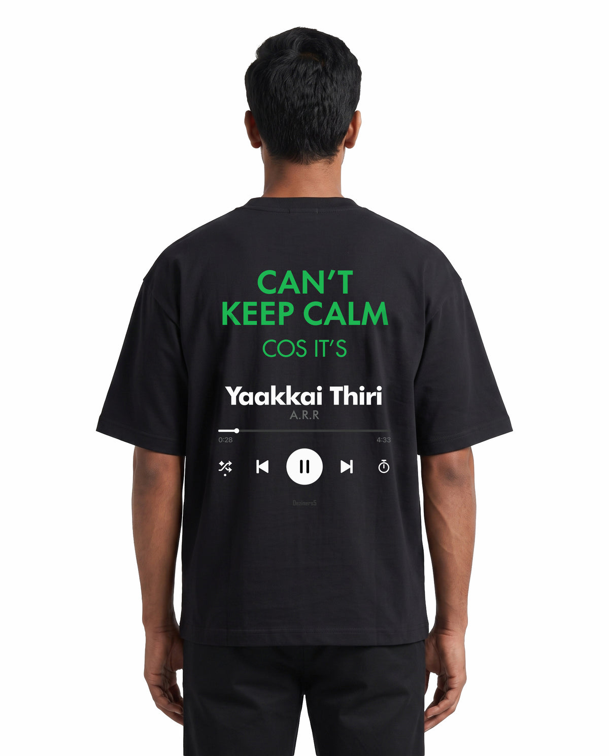 Back view of male model wearing THE ARR TRACK - TAMIZH - Unisex Oversized Graphic T-Shirt in black in a studio setting.