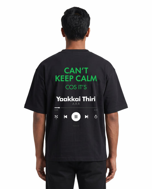 Back view of male model wearing THE ARR TRACK - TAMIZH - Unisex Oversized Graphic T-Shirt in black in a studio setting.
