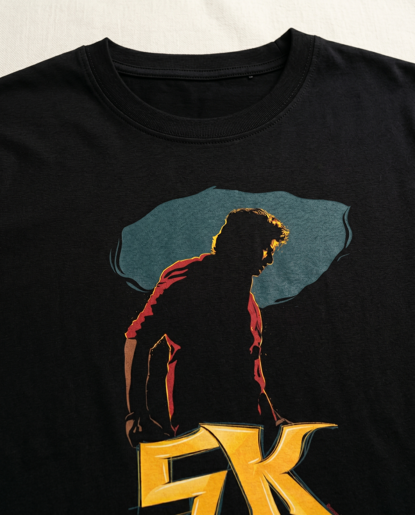 Close-up view of THE RISE OF SK graphic print highlighting premium print quality and illustration details on a black men's regular-fit t-shirt.