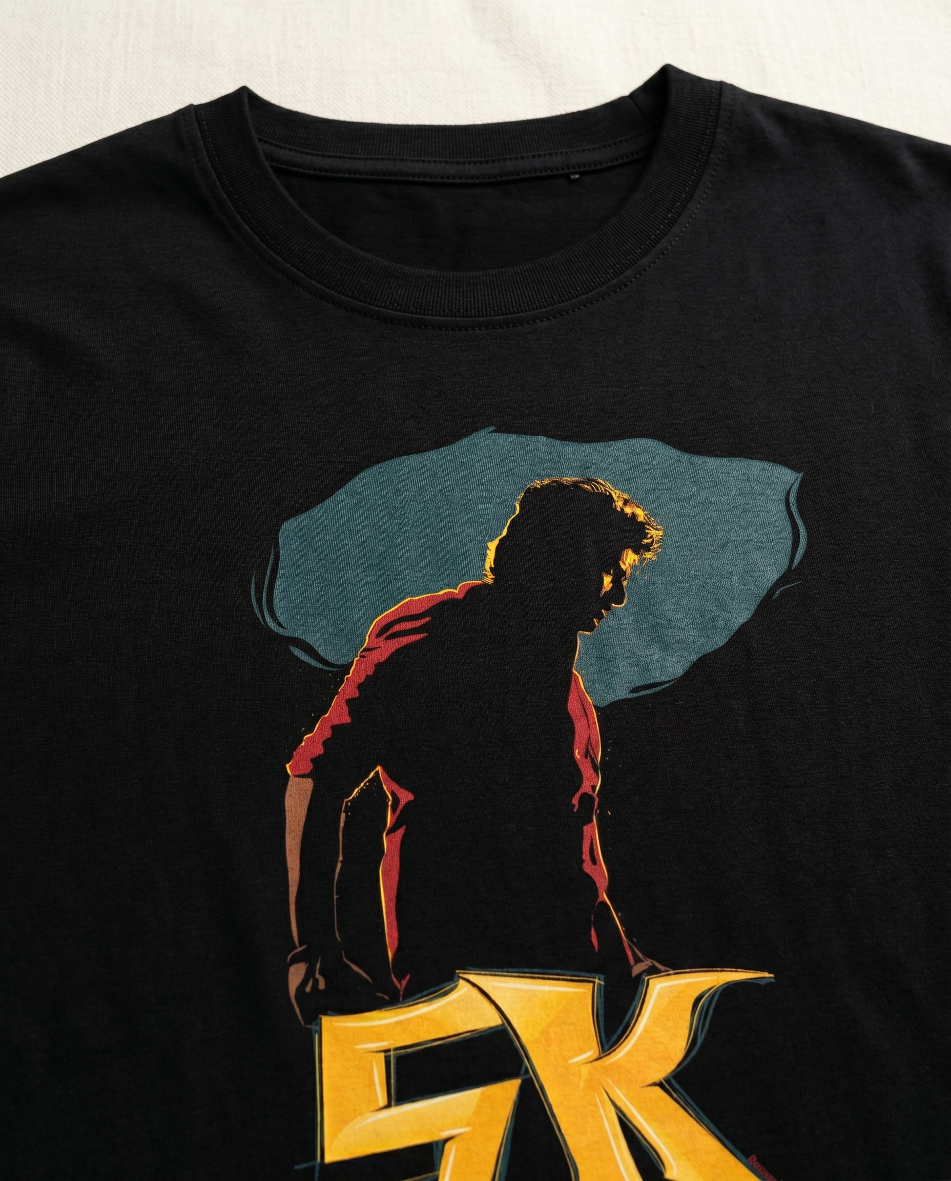 Close-up view of THE RISE OF SK graphic print highlighting premium print quality and illustration details on a black men's regular-fit t-shirt.