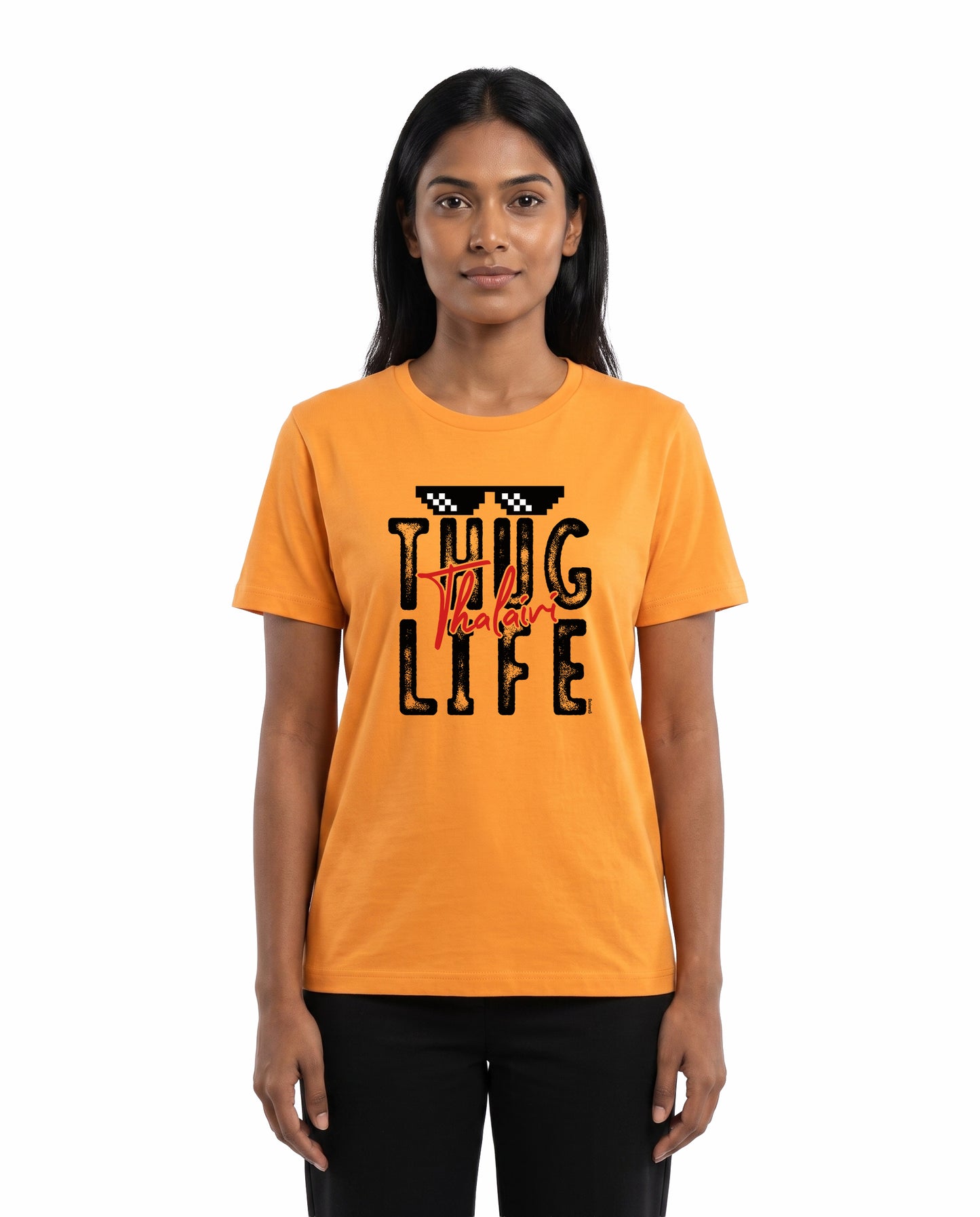 Female model wearing THUG LIFE THALAIVI women's regular-fit t-shirt in golden yellow in a studio setting.