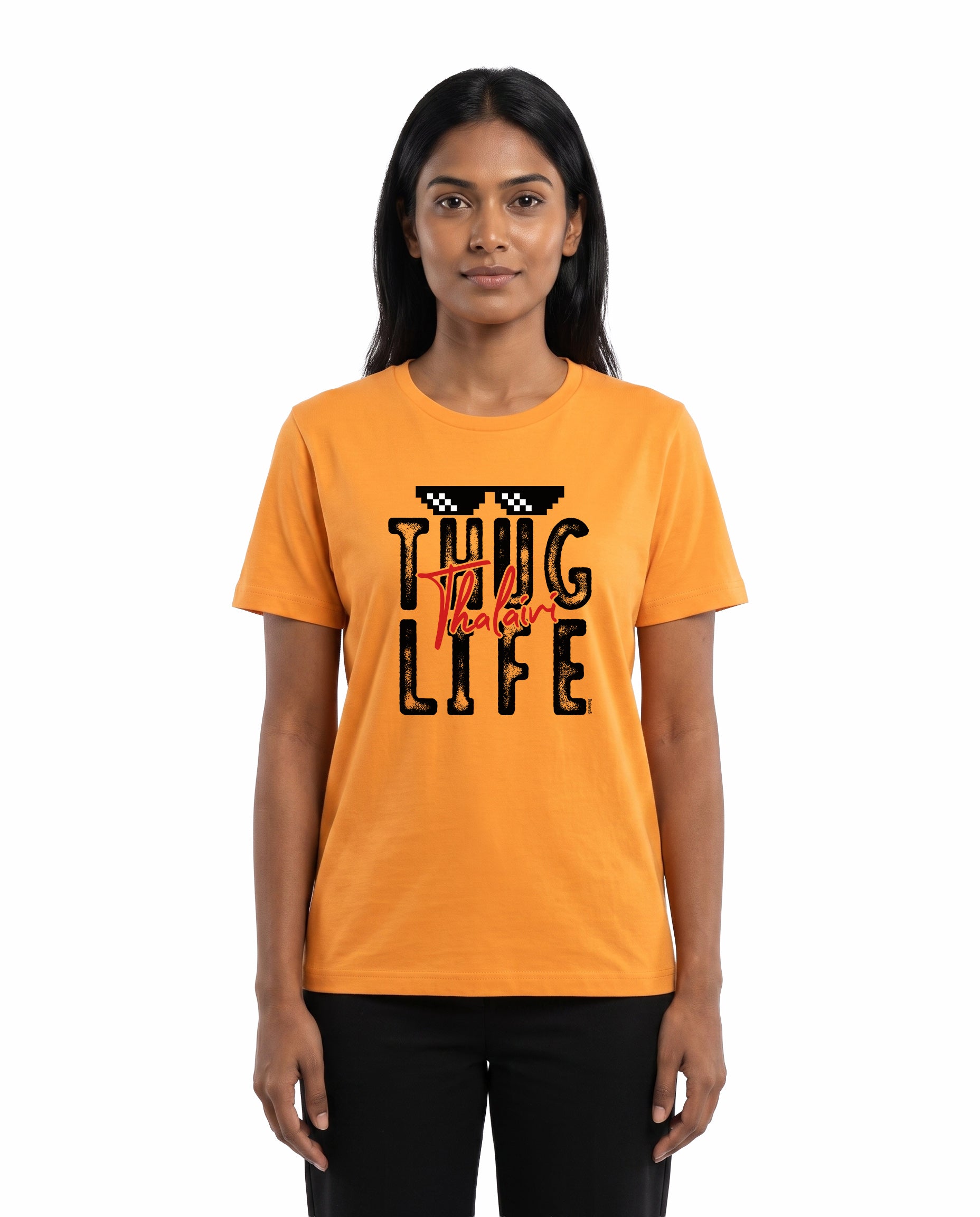 Female model wearing THUG LIFE THALAIVI women's regular-fit t-shirt in golden yellow in a studio setting.