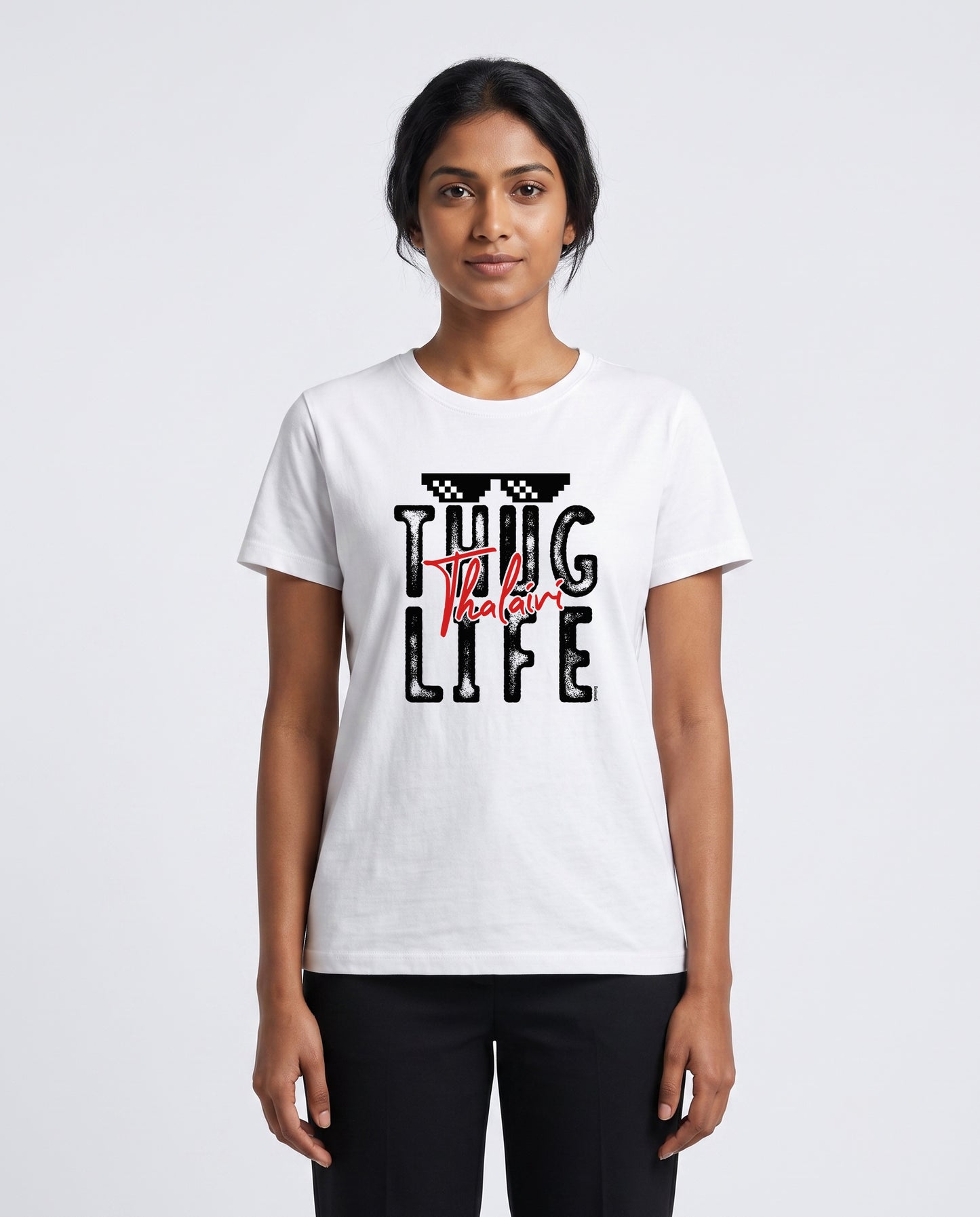 Female model wearing THUG LIFE THALAIVI women's regular-fit t-shirt in white in a studio setting.