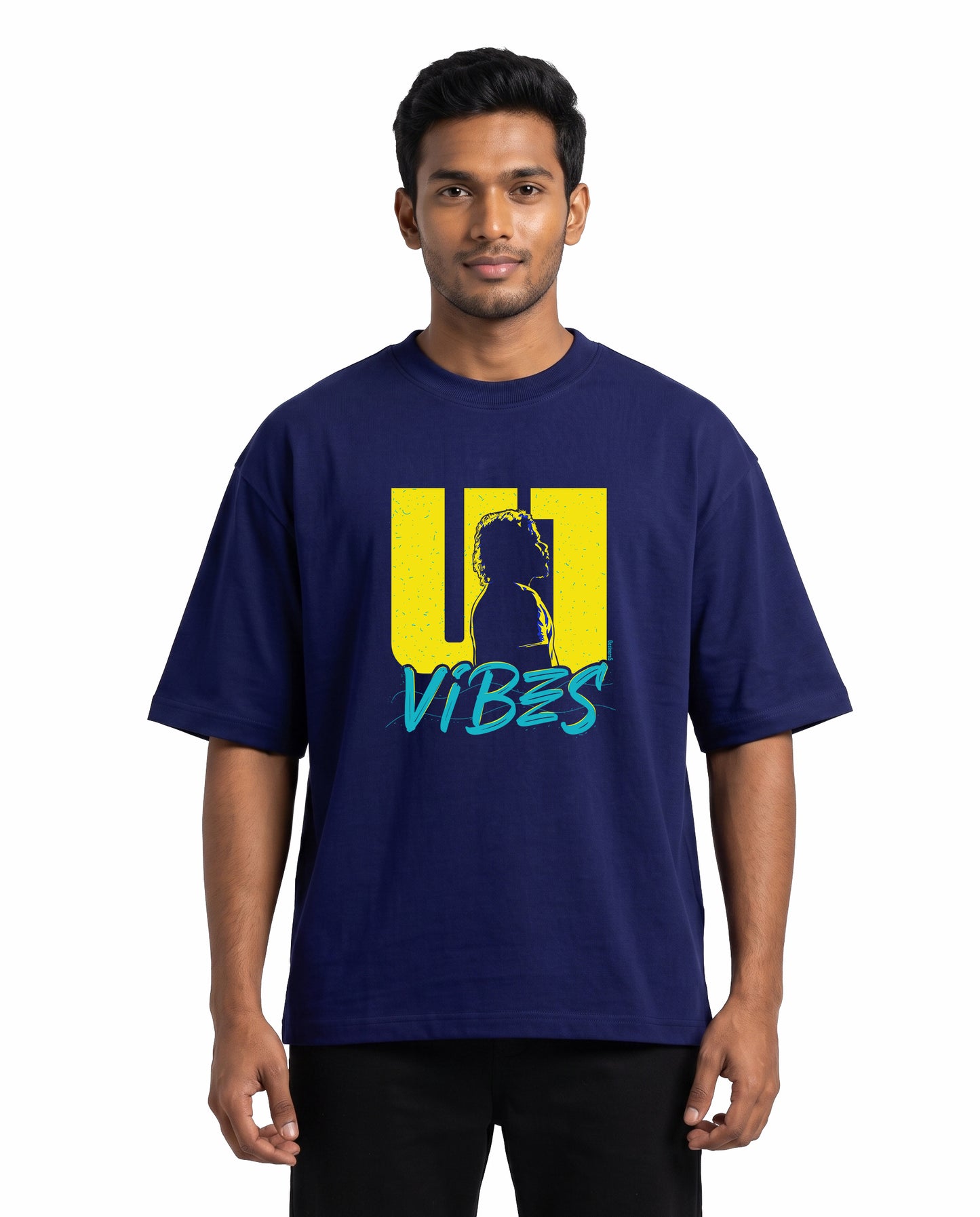 Front view of male model wearing U1 VIBES unisex oversized graphic t-shirt in royal blue in a studio setting.