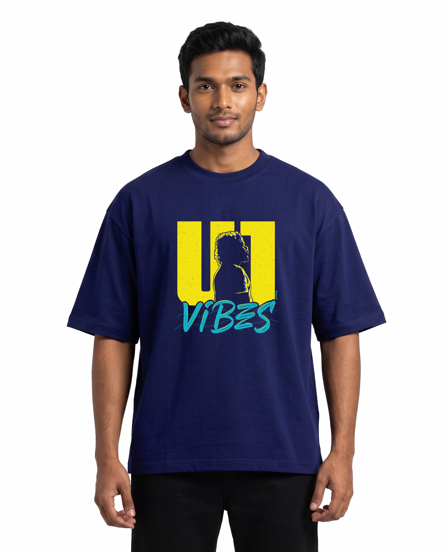 Front view of male model wearing U1 VIBES unisex oversized graphic t-shirt in royal blue in a studio setting.