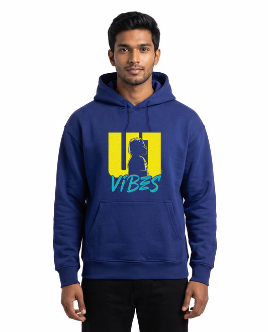 Front view of male model wearing U1 VIBES - unisex regular-fit hoodie in royal blue in a studio setting.