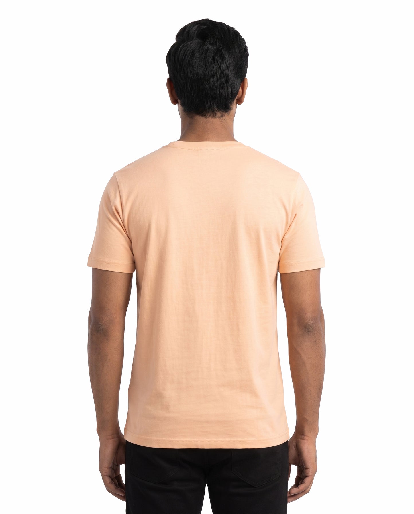 Back view of male model wearing UBER COOL men's regular-tit t-shirt in peach in a studio setting.