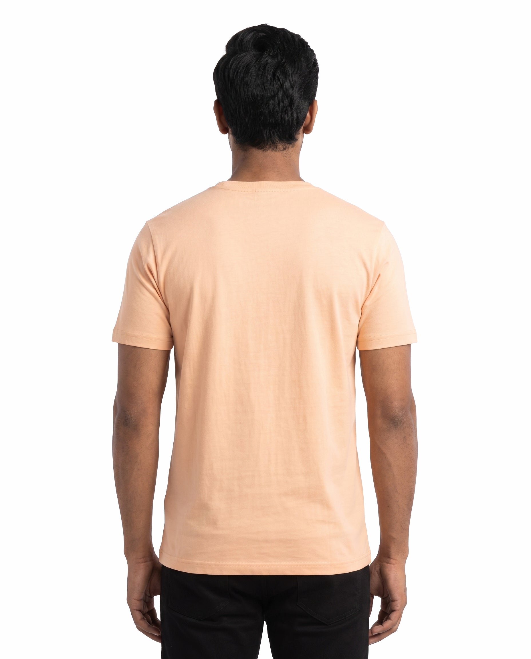 Back view of male model wearing UBER COOL men's regular-tit t-shirt in peach in a studio setting.