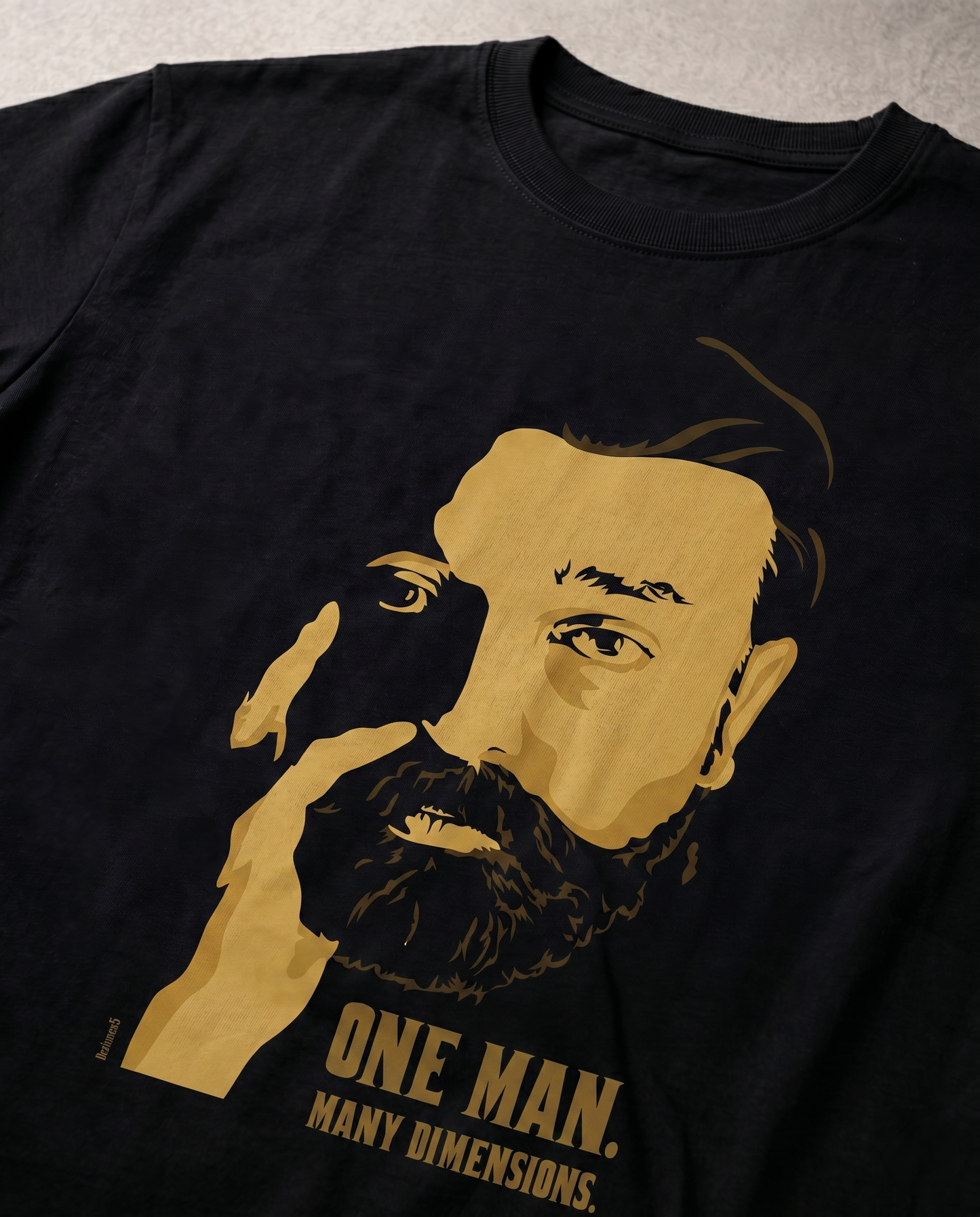 Close-up view of the ULAGANAYAGAN TRIBUTE front graphic print highlighting premium print quality on a black men's regular-fit t-shirt.