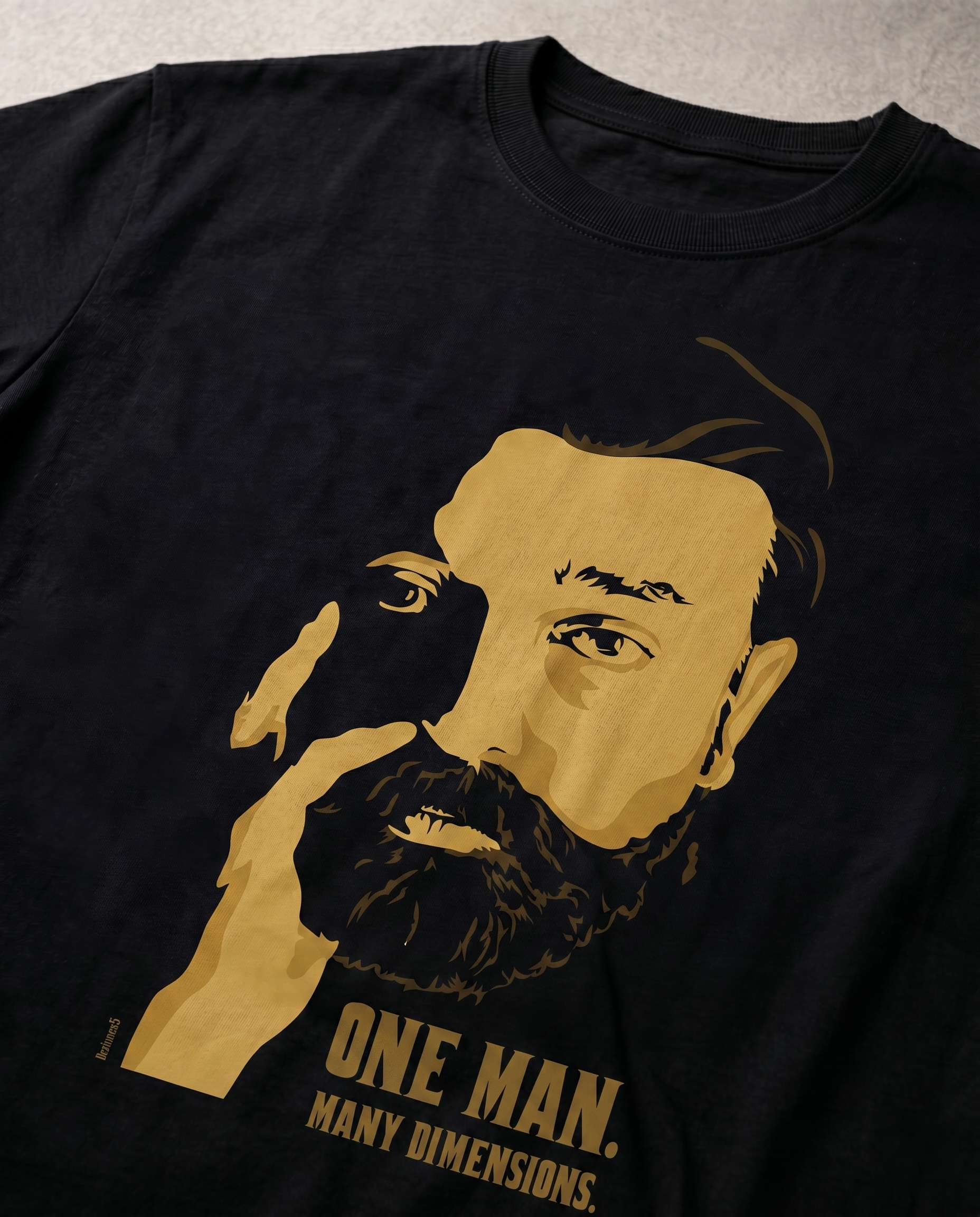 Close-up view of the ULAGANAYAGAN TRIBUTE front graphic print highlighting premium print quality on a black men's regular-fit t-shirt.