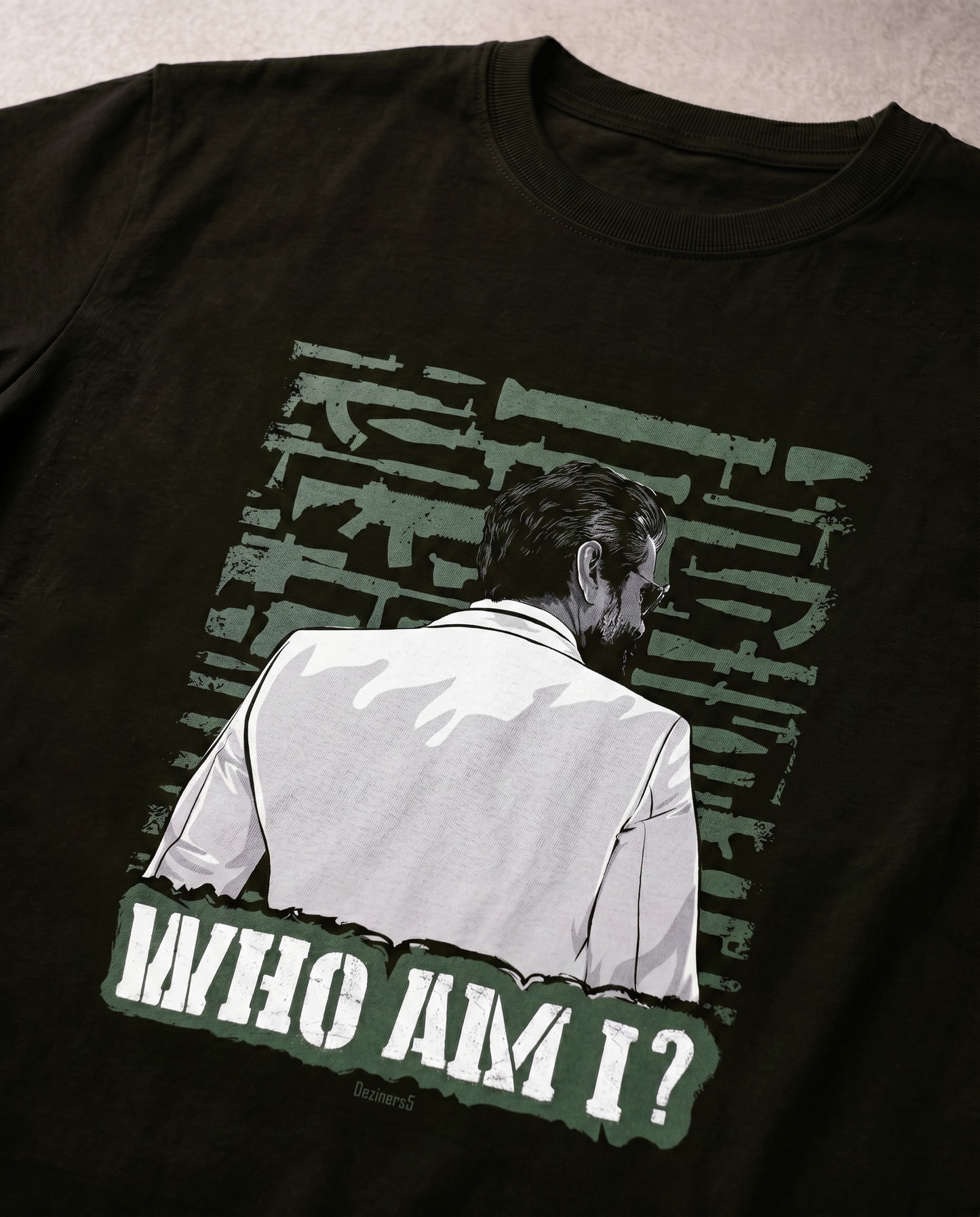 Detailed close-up of the WHO AM I illustrated graphic print highlighting premium print quality and artwork details on an olive green men's regular-fit t-shirt.