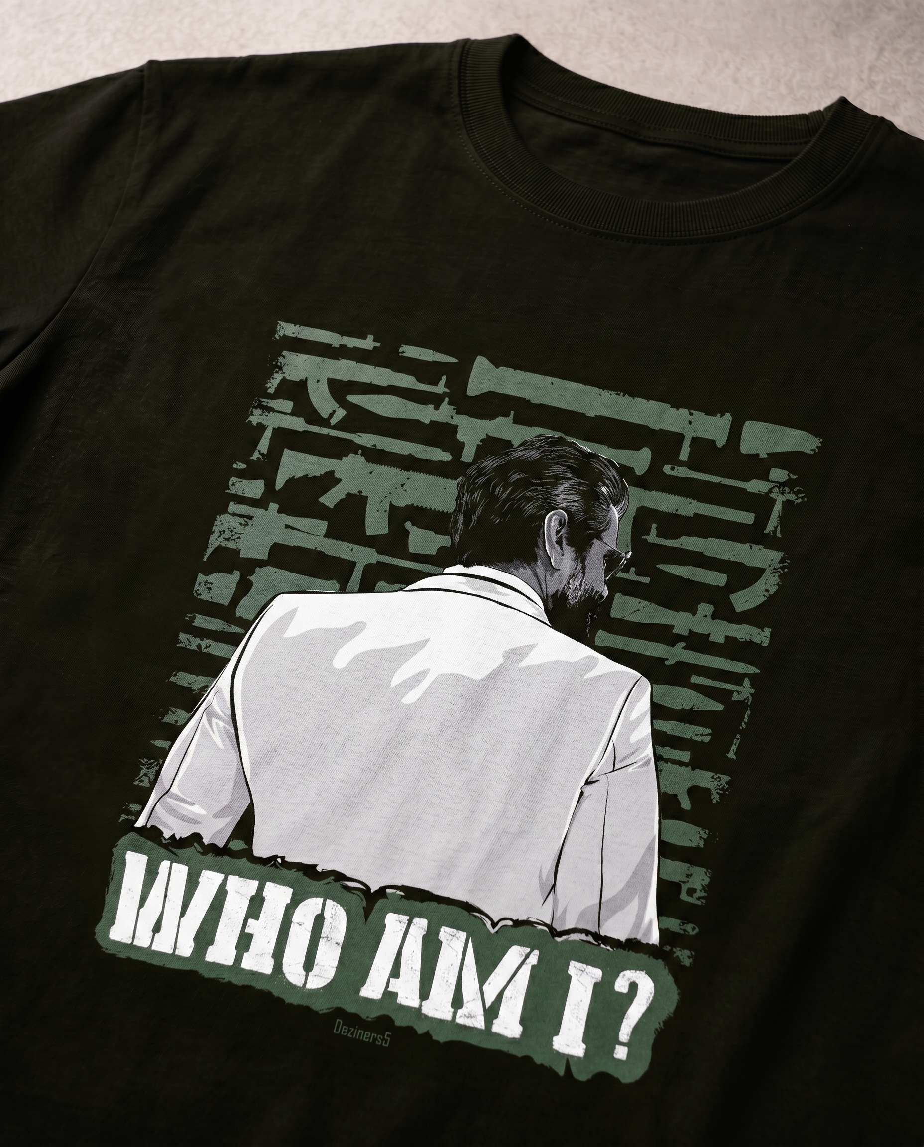Detailed close-up of the WHO AM I illustrated graphic print highlighting premium print quality and artwork details on an olive green men's regular-fit t-shirt.